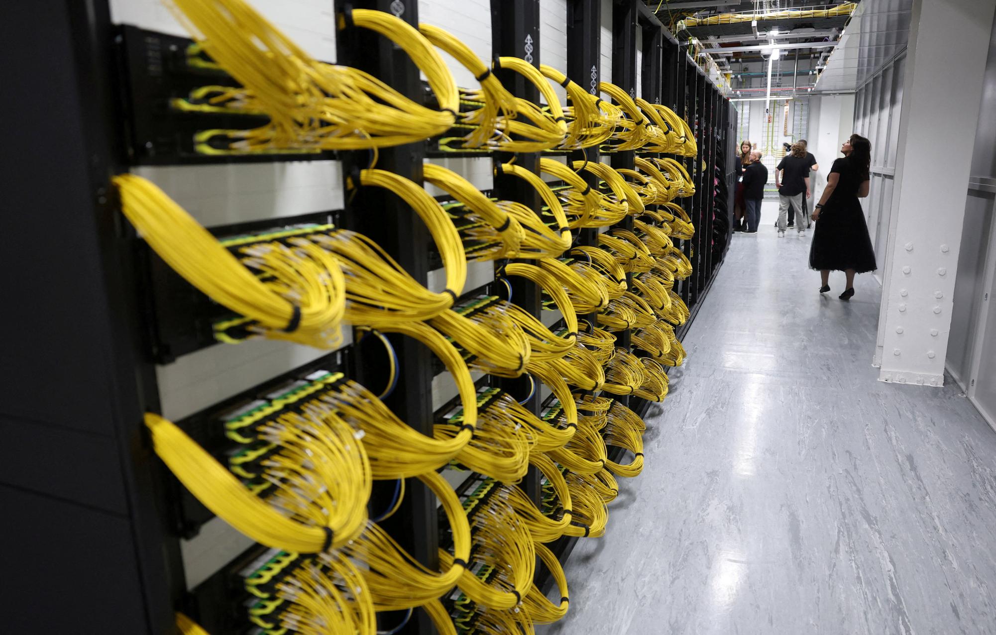 Visitors view racks for data servers, GPUs and CPUs during a tour inside the Nebius AI UK data centre, a new facility hosting NVIDIA and other computer firms, at Ark Data Centres, in Chertsey, Britain, November 6, 2025. REUTERS/Toby Melville