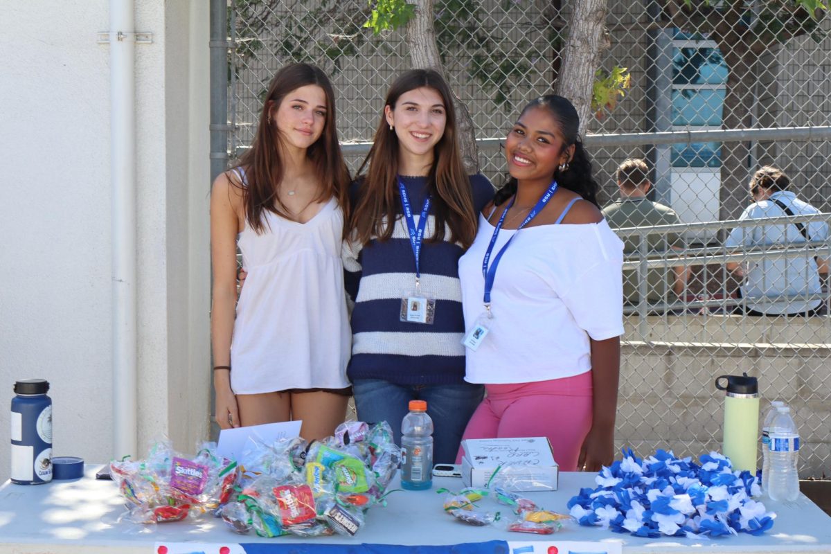Candy being sold right next to the home side entrance to the seating for family of graduating seniors.