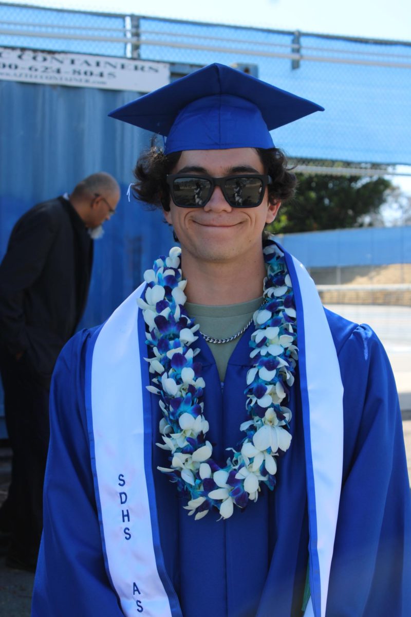 Dillon Smith experiences the heat of the day as he prepares to walk out onto the stage. Smith hopes to go into community then state college and eventually go into the film industry.